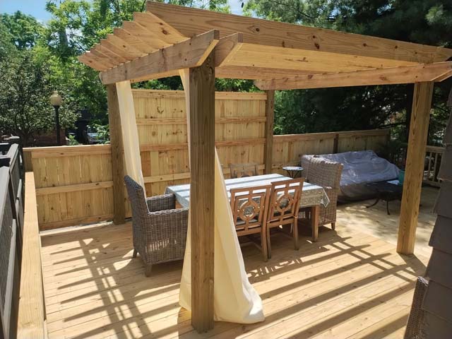 Deck seating area with wood arbor overhead